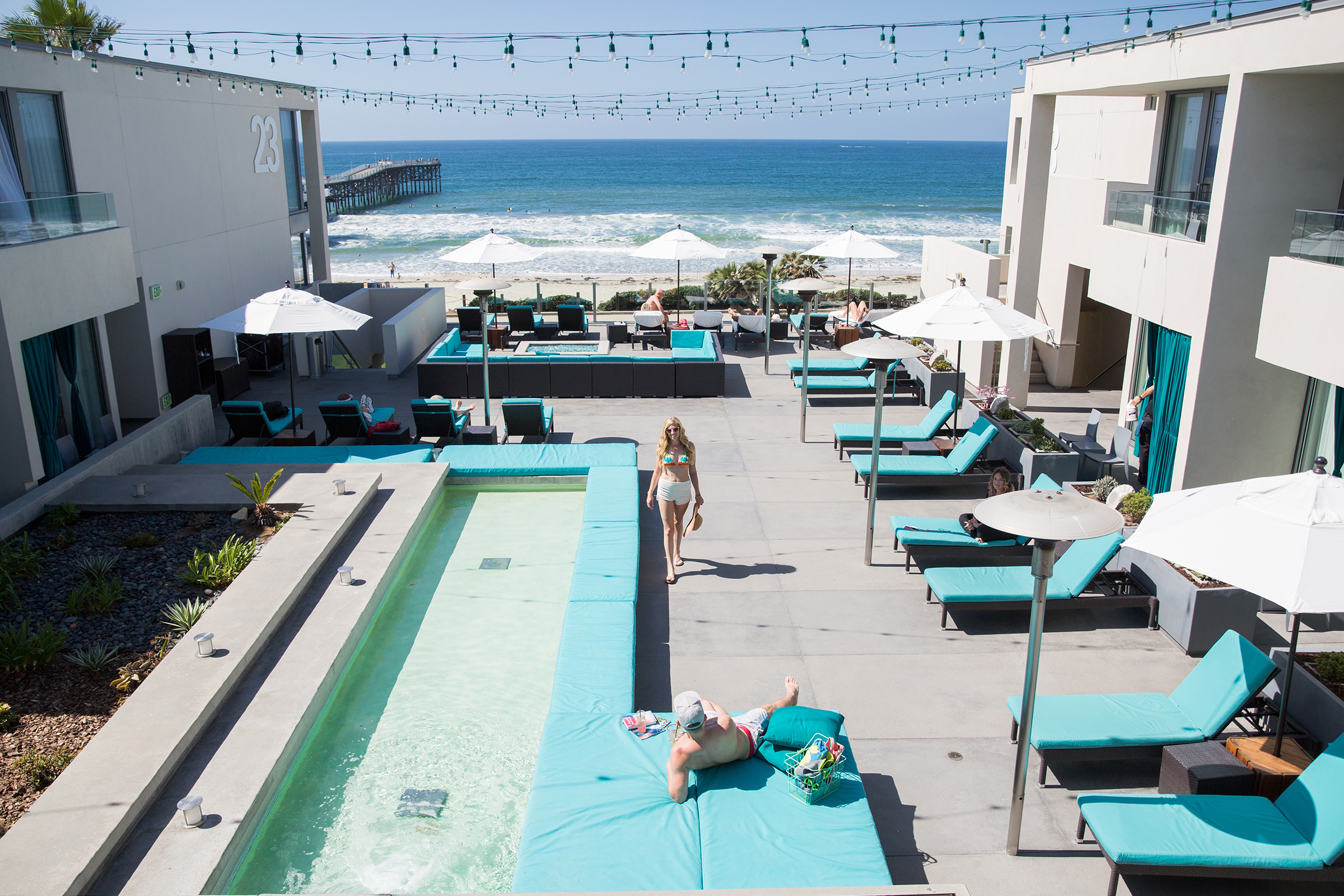 View of Tower Deck at Tower23 hotel with guests enjoying the sun and ocean it sits on