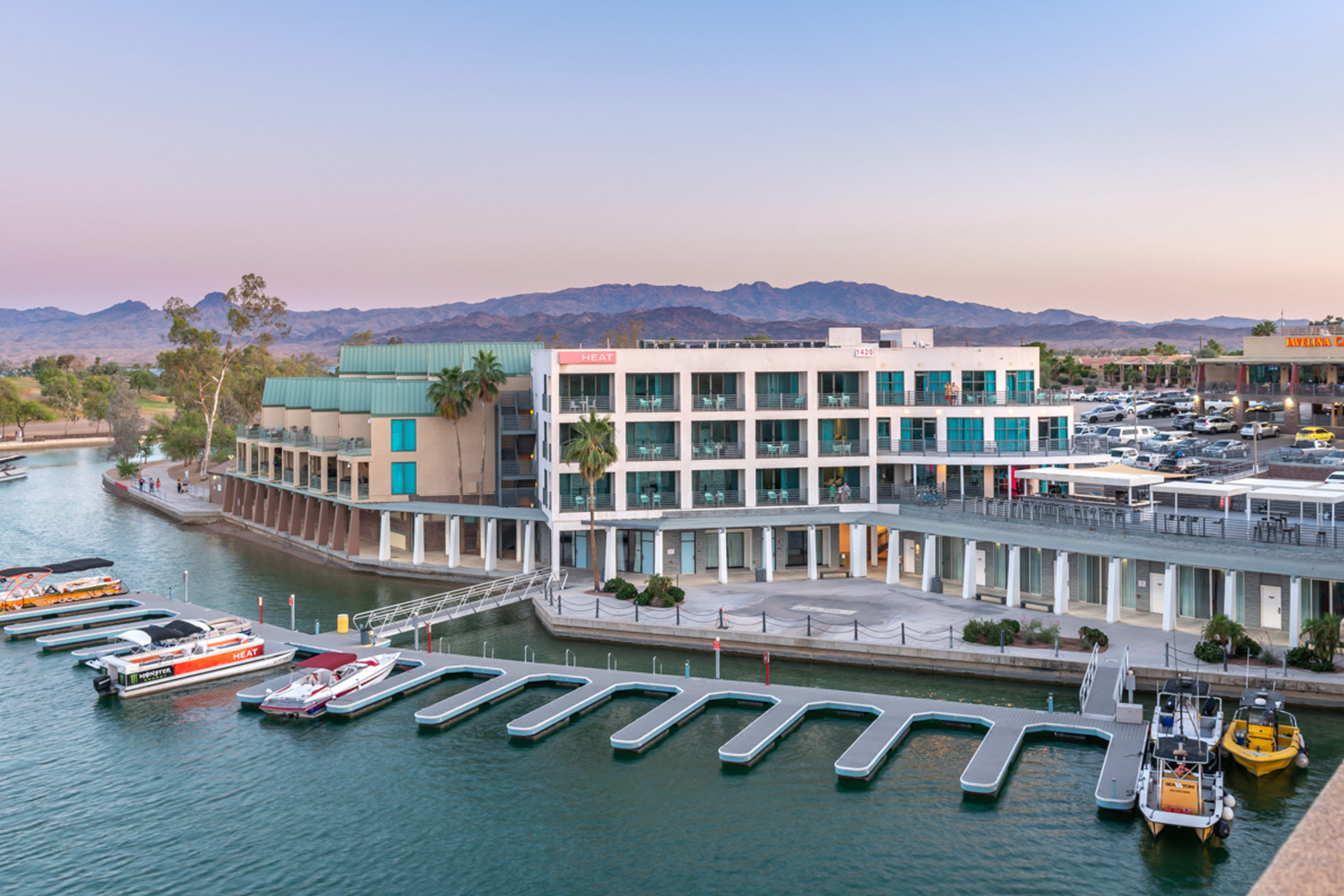 View of Heat Hotel with boat slips in the water and view of mountains in the background