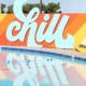 Colorful CHILL sign and its reflection on the pool