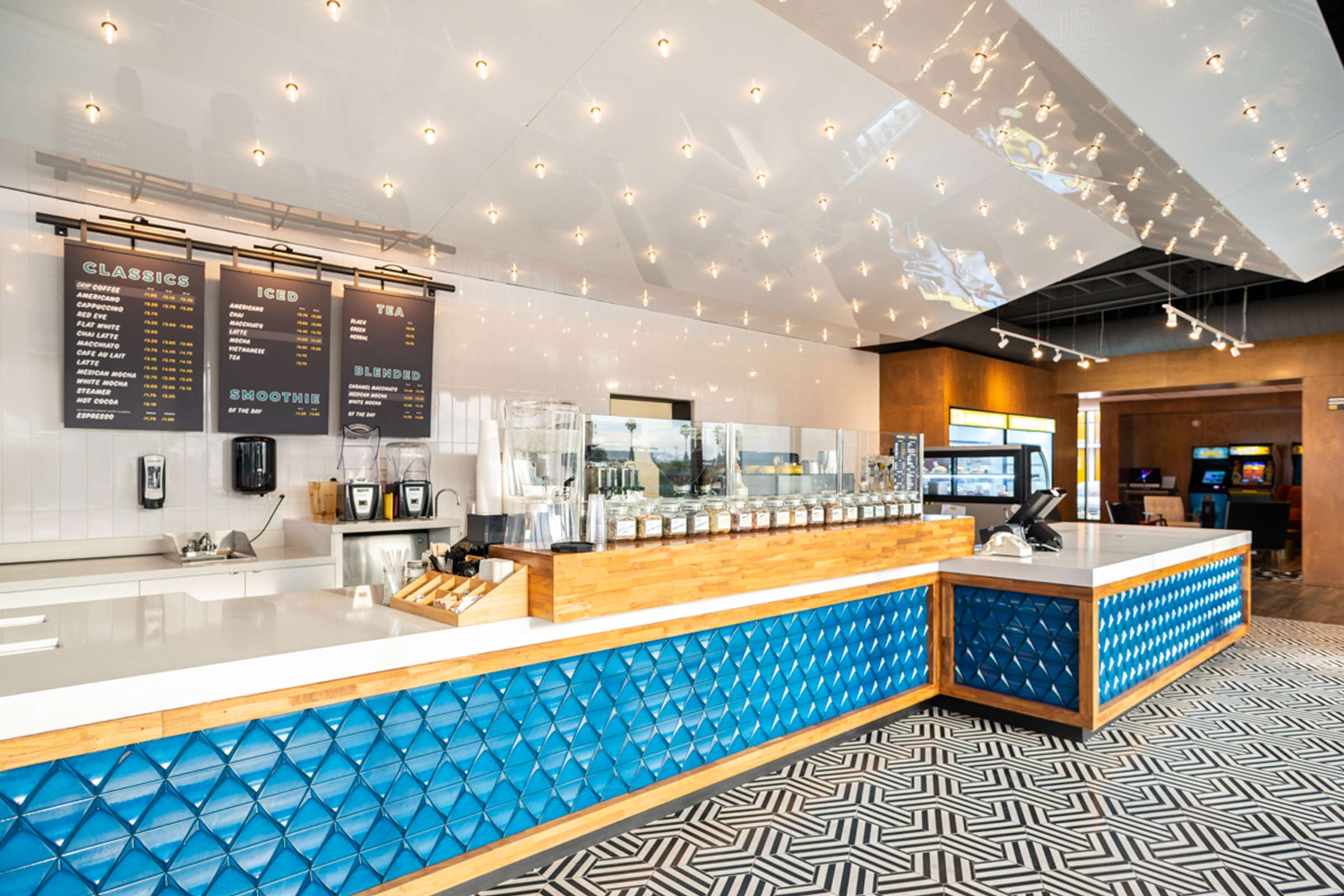 Rambler Coffee ordering counter with blue fasade and black and white tile floor