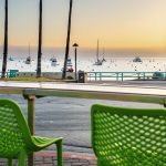 Green bar chairs overlooking Avalon Harbor at The Naughty Fox