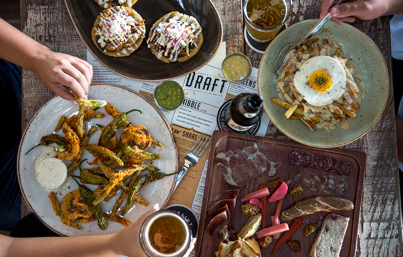 View of table from above of plated dishes from Draft in Mission Beach