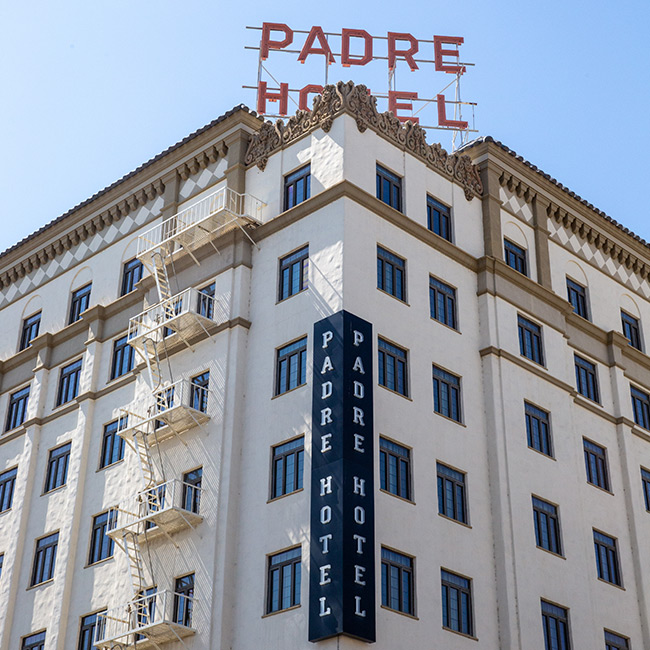 The Padre Hotel exterior with view of red Padre Hotel sign