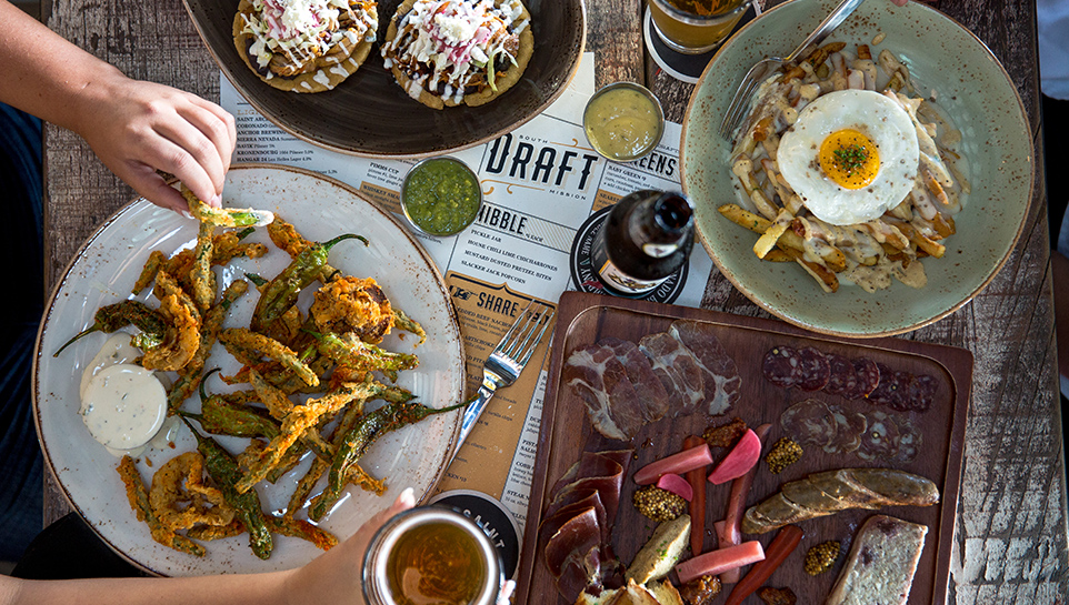 View of table from above of plated dishes from Draft in Mission Beach